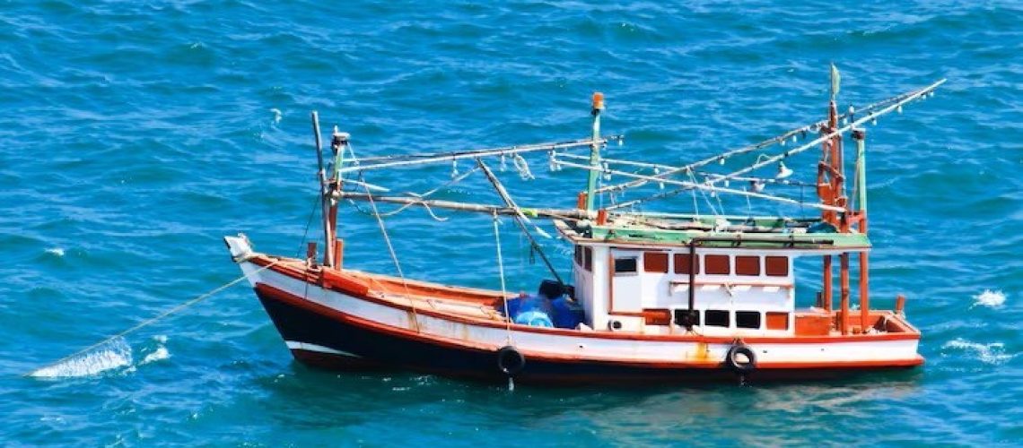 barco-de-pesca-de-madeira-no-mar_11823-233